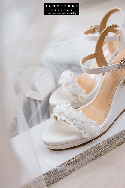 Side view of matte white leather canoe heels with white rose lace trim, perfect for weddings.