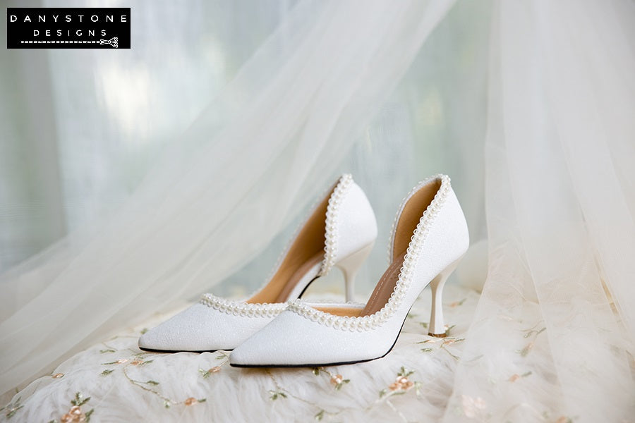 Side view of wedding shoes with pearl trim, metallic scratched leather, perfect for brides.