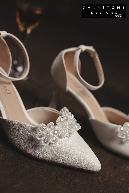 Close-up of crystal beaded floral design on elegant bridal heels, showcasing intricate details.