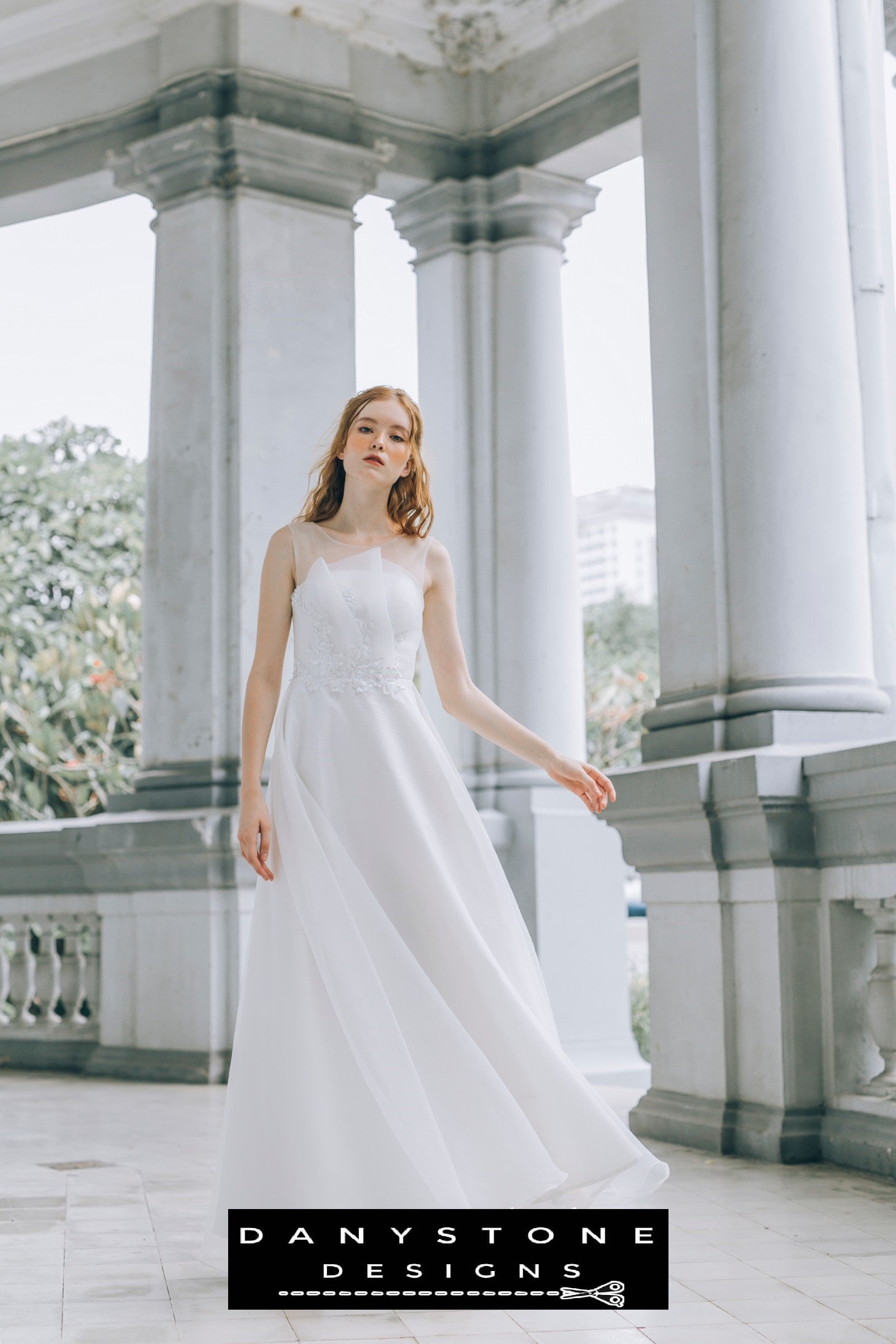 Front view of a bride in a pleated chest wedding dress with floral lace details