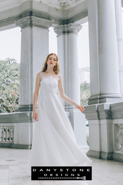 Front view of a bride in a pleated chest wedding dress with floral lace details