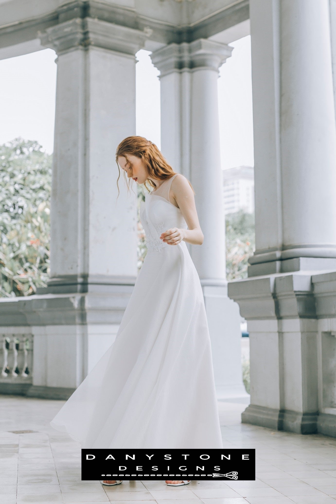 Side view of a bride in a flowing pleated chest wedding dress