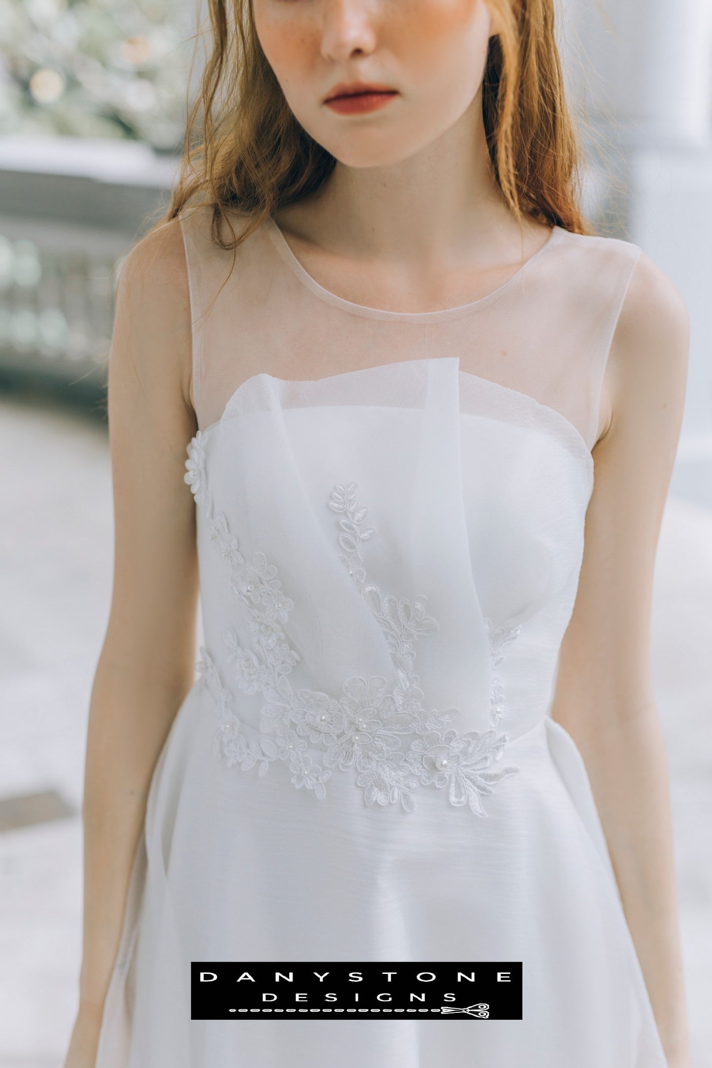 Close-up of floral lace applique on pleated chest wedding dress