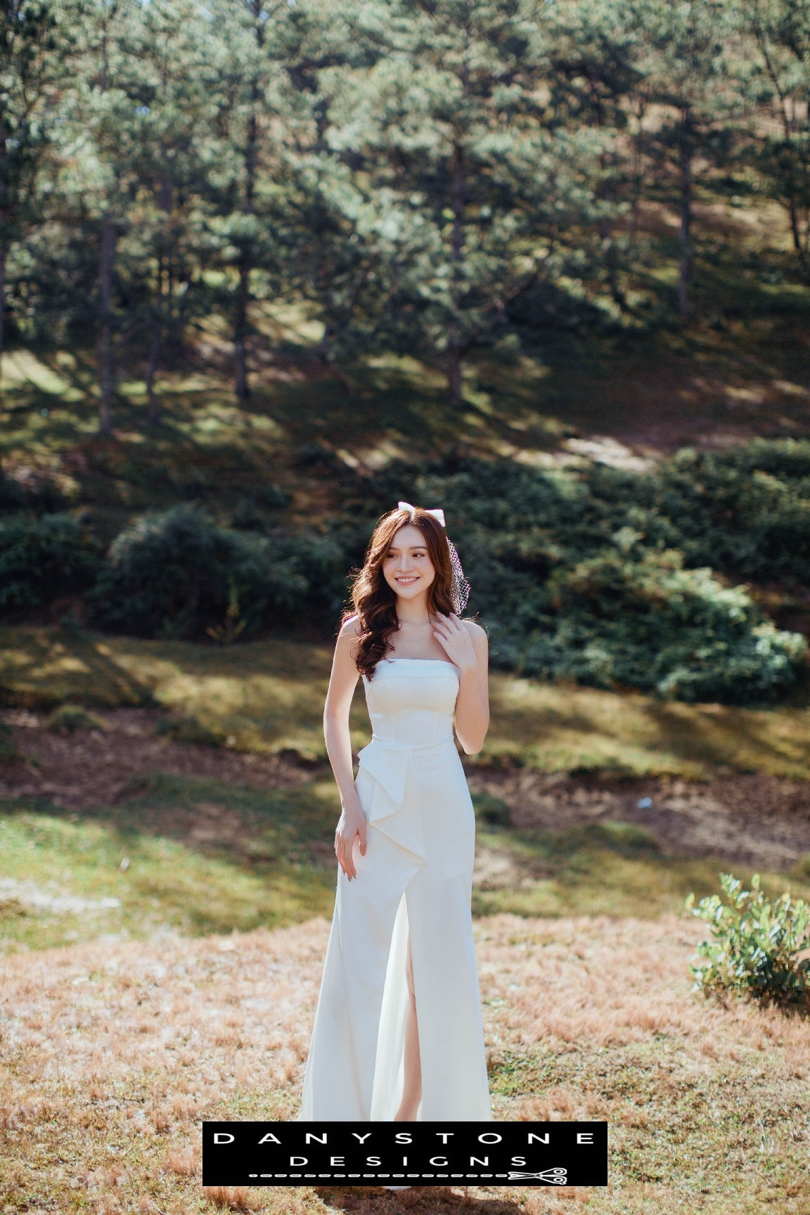 Stylish strapless wedding dress with unique bow accent and chic front slit – Danystone Designs