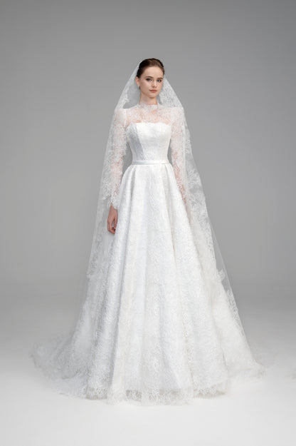 White wedding dress with a long veil on a gray background