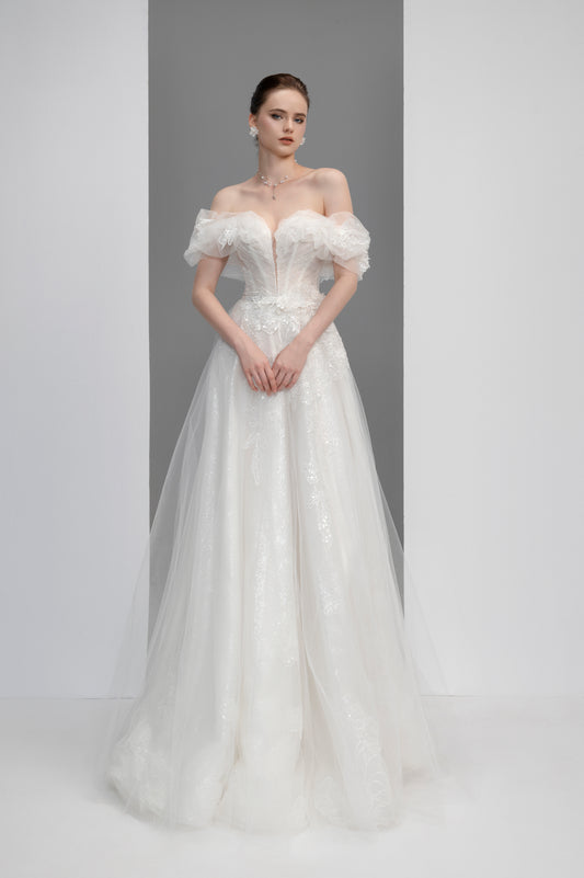 White wedding dress with floral details on a plain background