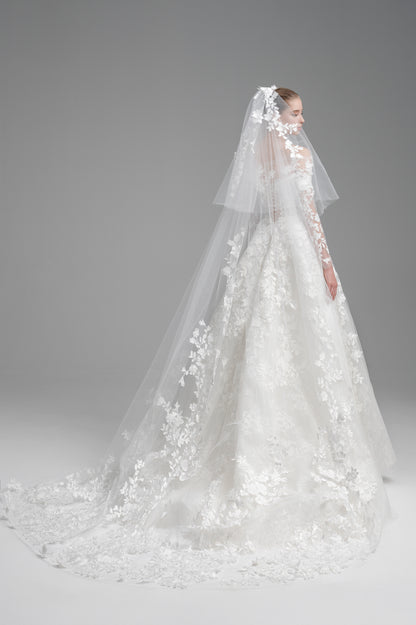 Elegant white wedding dress with a long veil on a gray background