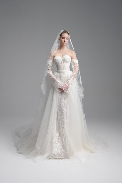 White wedding dress with lace detailing on a gray background