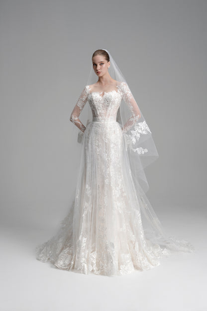 White wedding dress with long sleeves and a veil on a gray background