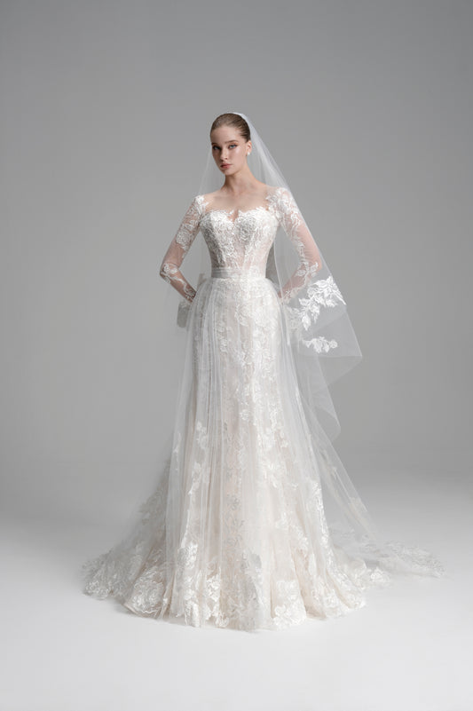 White wedding dress with long sleeves and a veil on a gray background