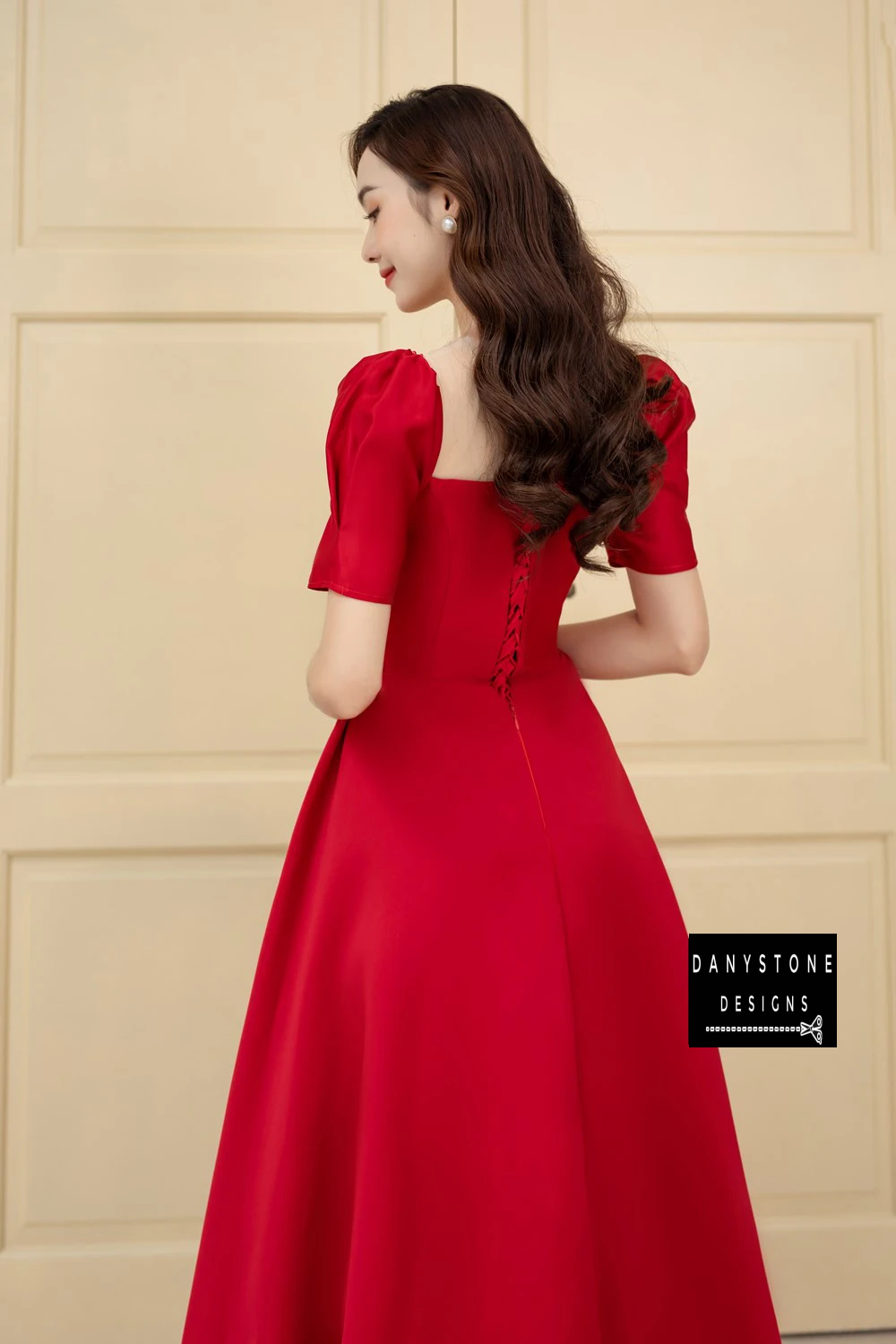 Back View of Elegant Red Ruffled Wedding Dress Showcasing Flowing Skirt