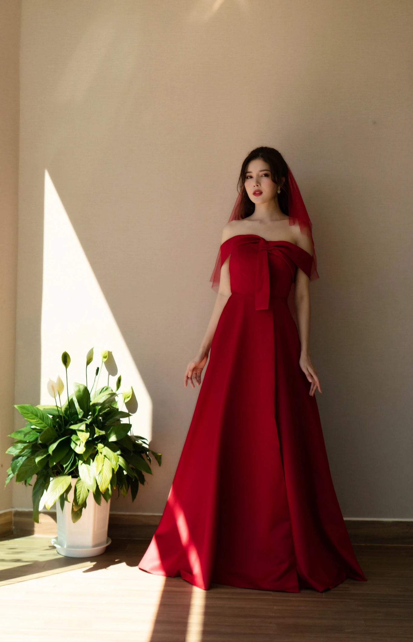 Bride Adjusting Veil in Red Off-the-Shoulder Wedding Dress