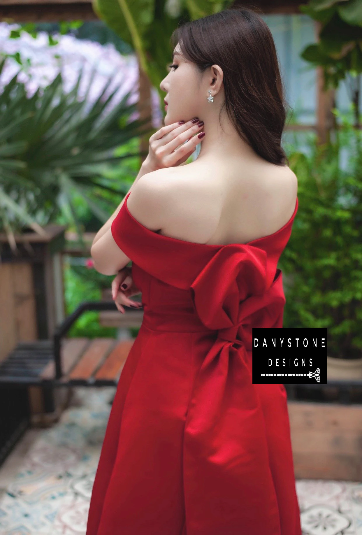 Back View of Red Off-the-Shoulder Wedding Dress Highlighting Bow Train