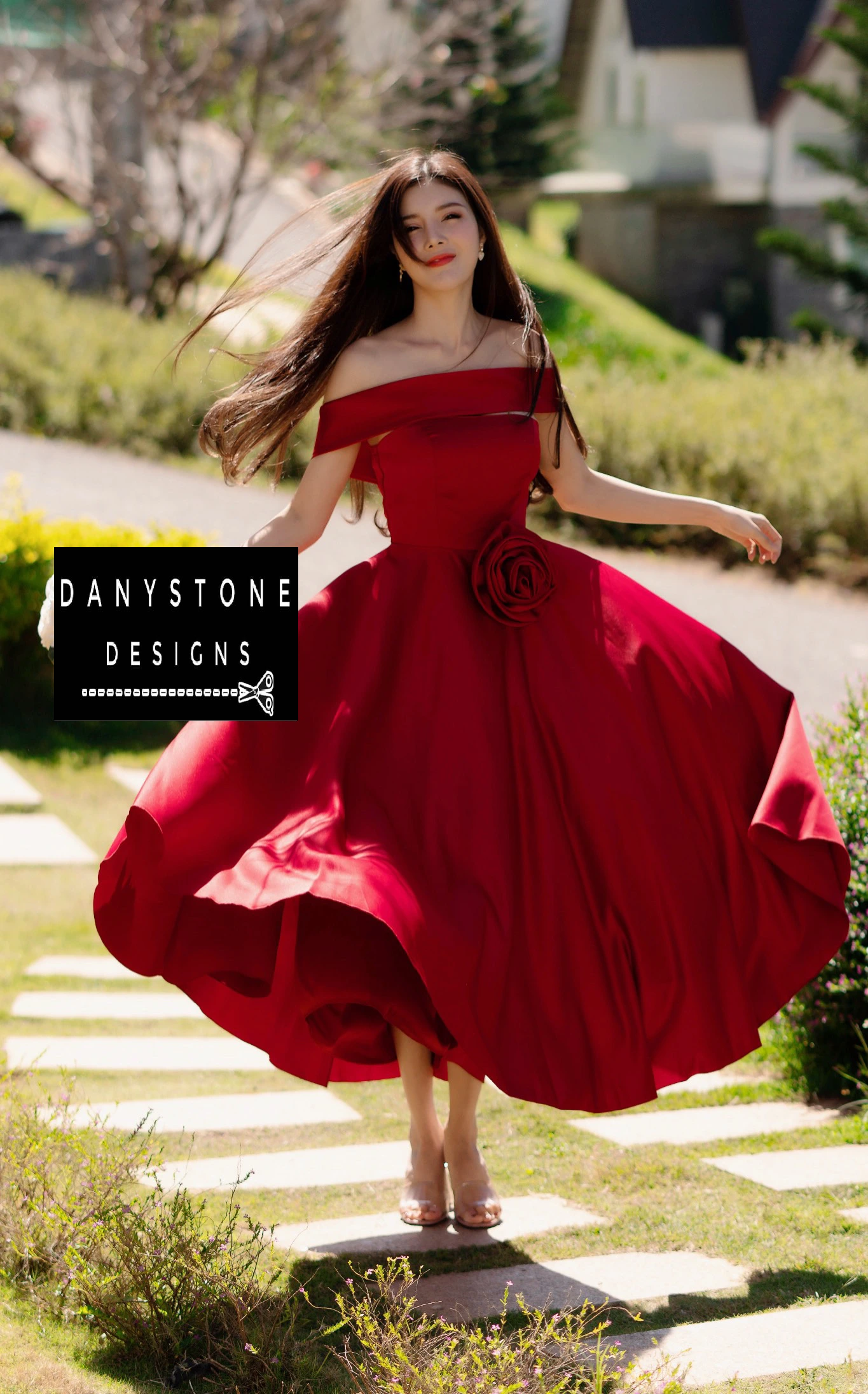 "Model spinning in elegant red off-shoulder dress"