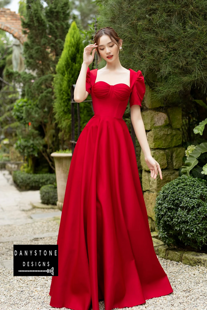 Bride in Luxurious Red Pleated Puff-Sleeve Wedding Dress in Garden Setting