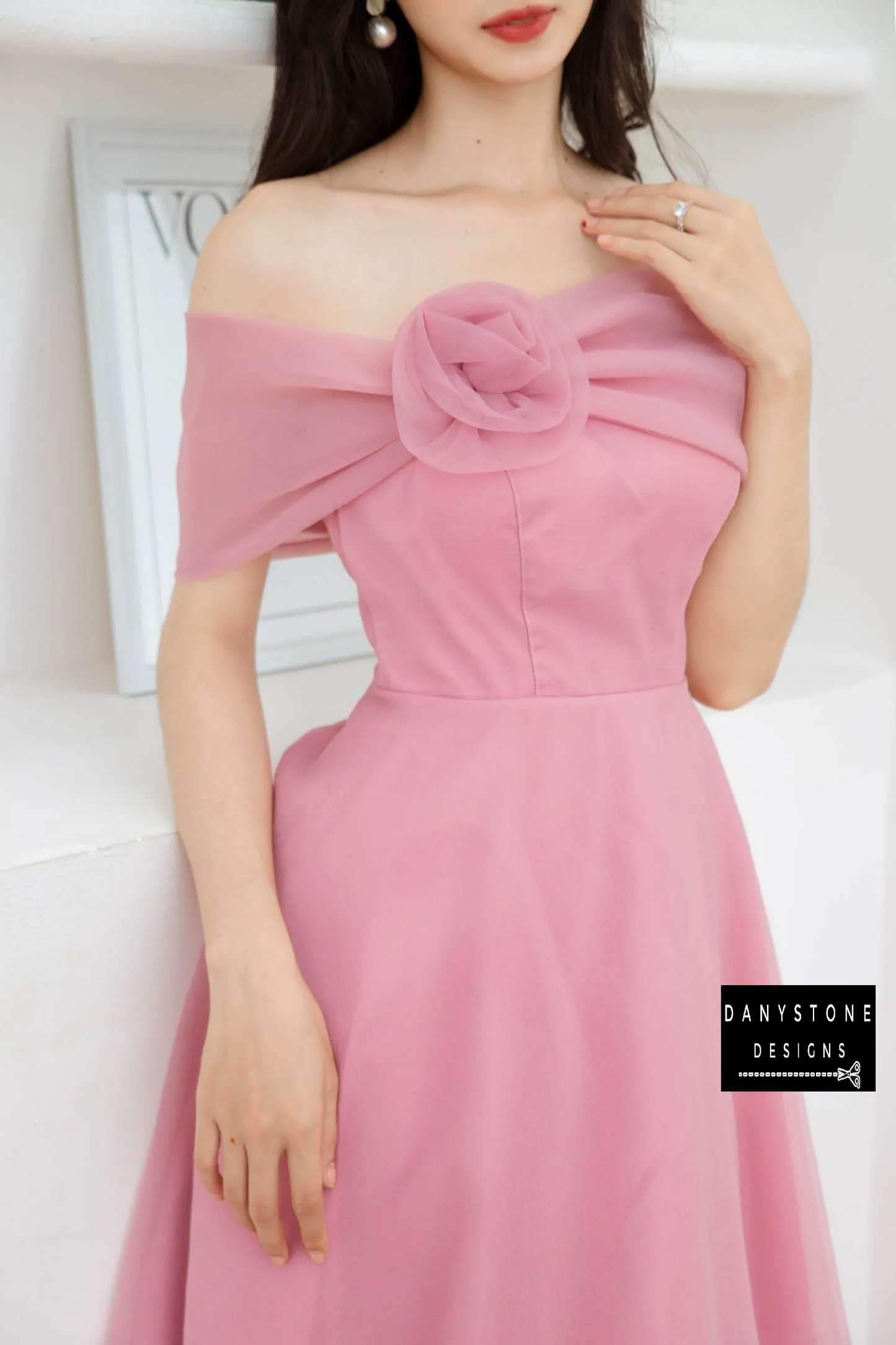 Front View of Pink Off-the-Shoulder Wedding Dress Highlighting Rose Detail