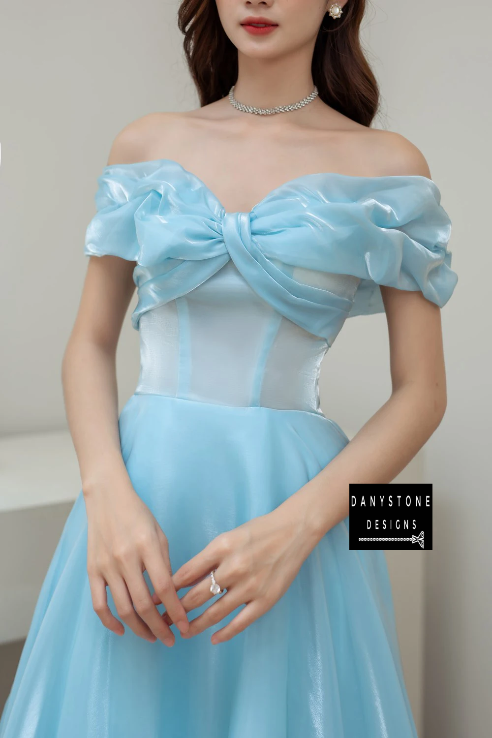 Close-Up of Off-the-Shoulder Bow Design on Blue Silk Wedding Dress