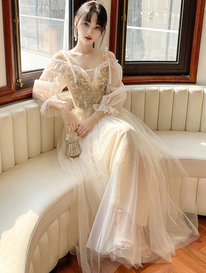 Model wearing a romantic champagne tulle evening party maxi dress