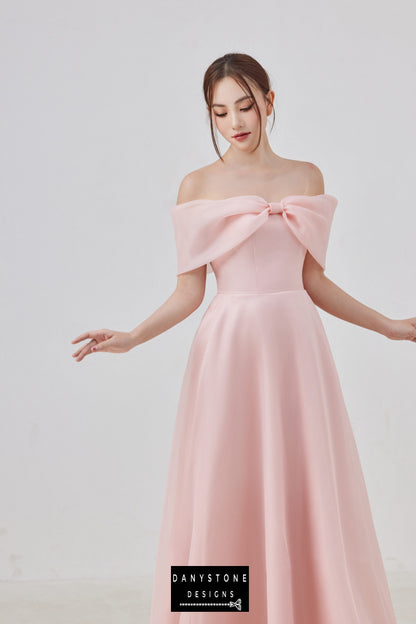 Woman in a pink off-shoulder dress with a chest bow made from satin and silk chiffon