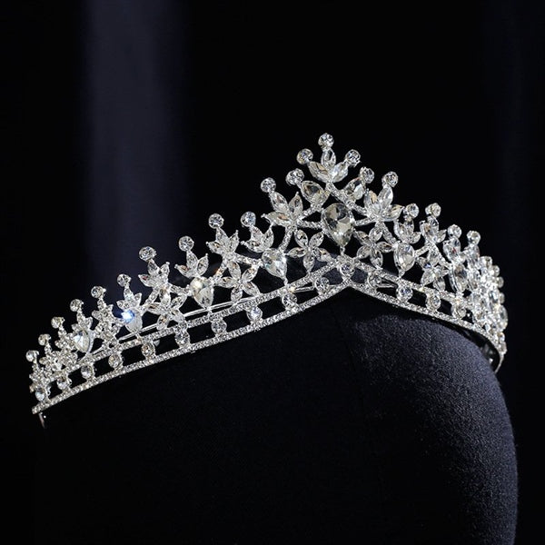 Embrace timeless elegance with our Elegant Floral Crystal Bridal Crown. This exquisite crown features a delicate floral design adorned with sparkling crystals, creating a radiant and graceful look. Perfect for brides who want to add a touch of refined beauty to their wedding day ensemble, this crown complements both traditional and modern bridal styles with ease.