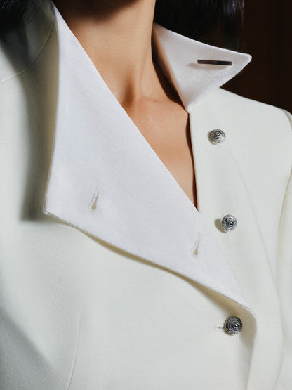 Close-up of a white coat with buttons on a dark background