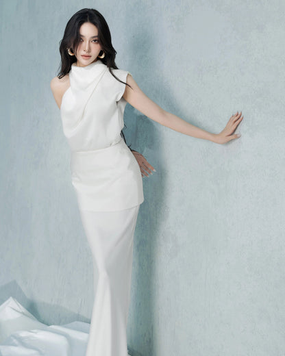 Woman in a white dress against a light blue background