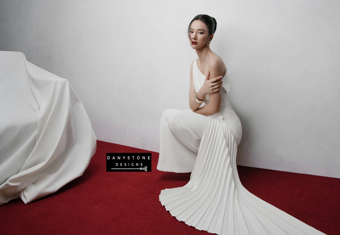 Detailed View of Pleated Skirt on White Gown