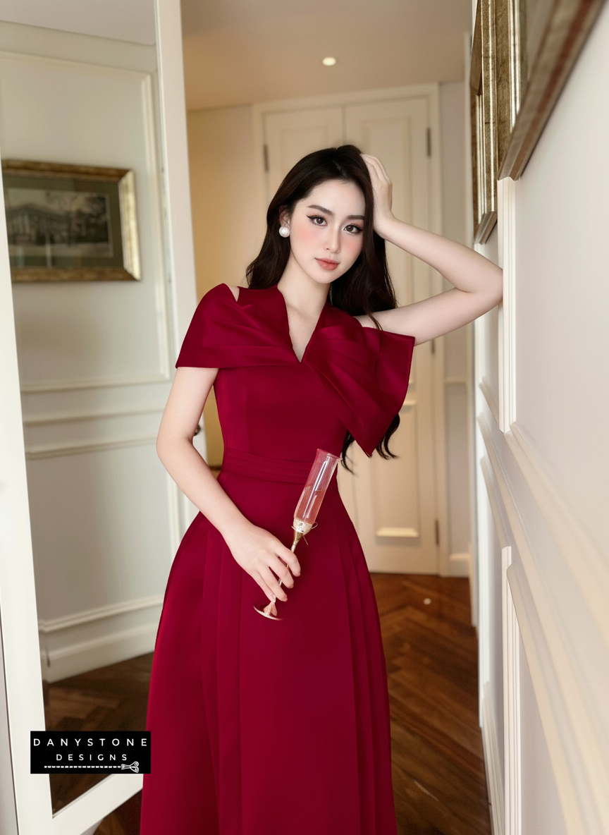 Woman in a red dress holding a glass in an indoor setting