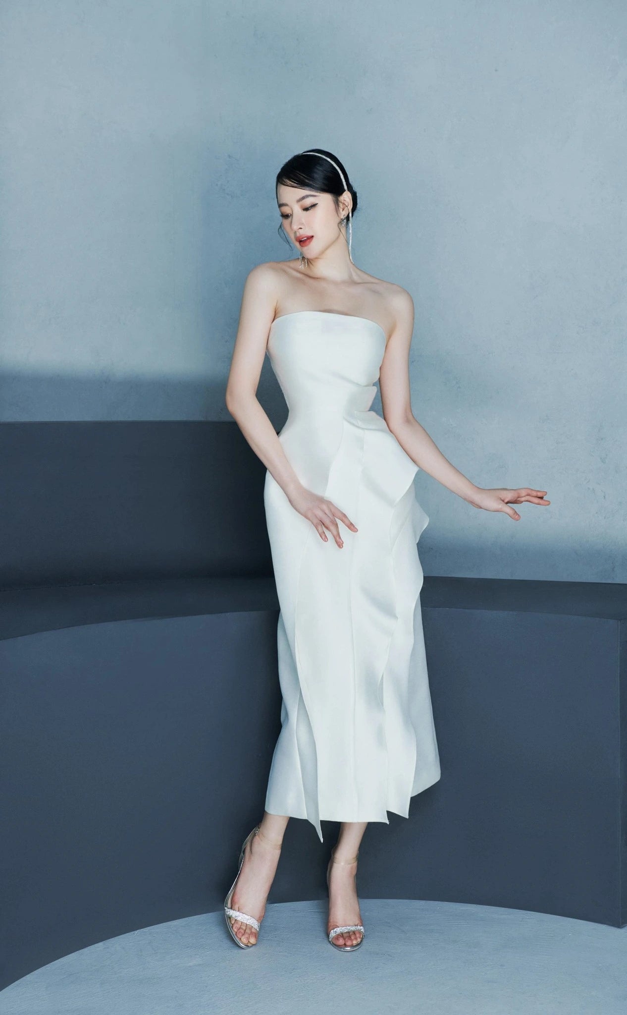 Simple and elegant ruffled front strapless dress in white - angled view