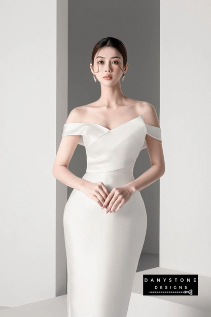 Model showcasing Belle of the Ball off-shoulder dress with puffy skirt in white