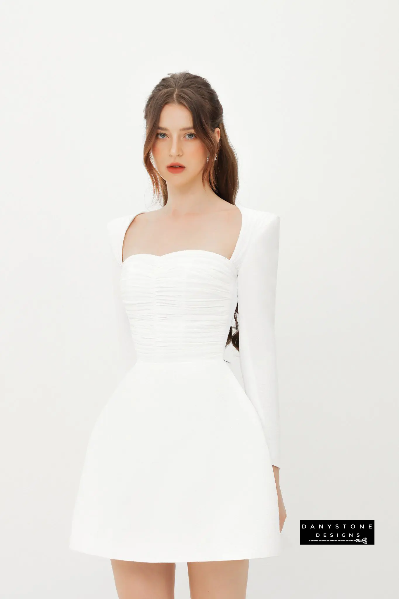 Front View of White Silk-Pressed Long Sleeve U-Neck A-Line Dress in a Minimalist Setting