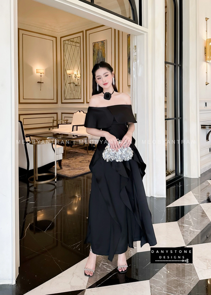 Model Wearing Black Off-Shoulder Ruffled Skirt Dress in Luxurious Setting