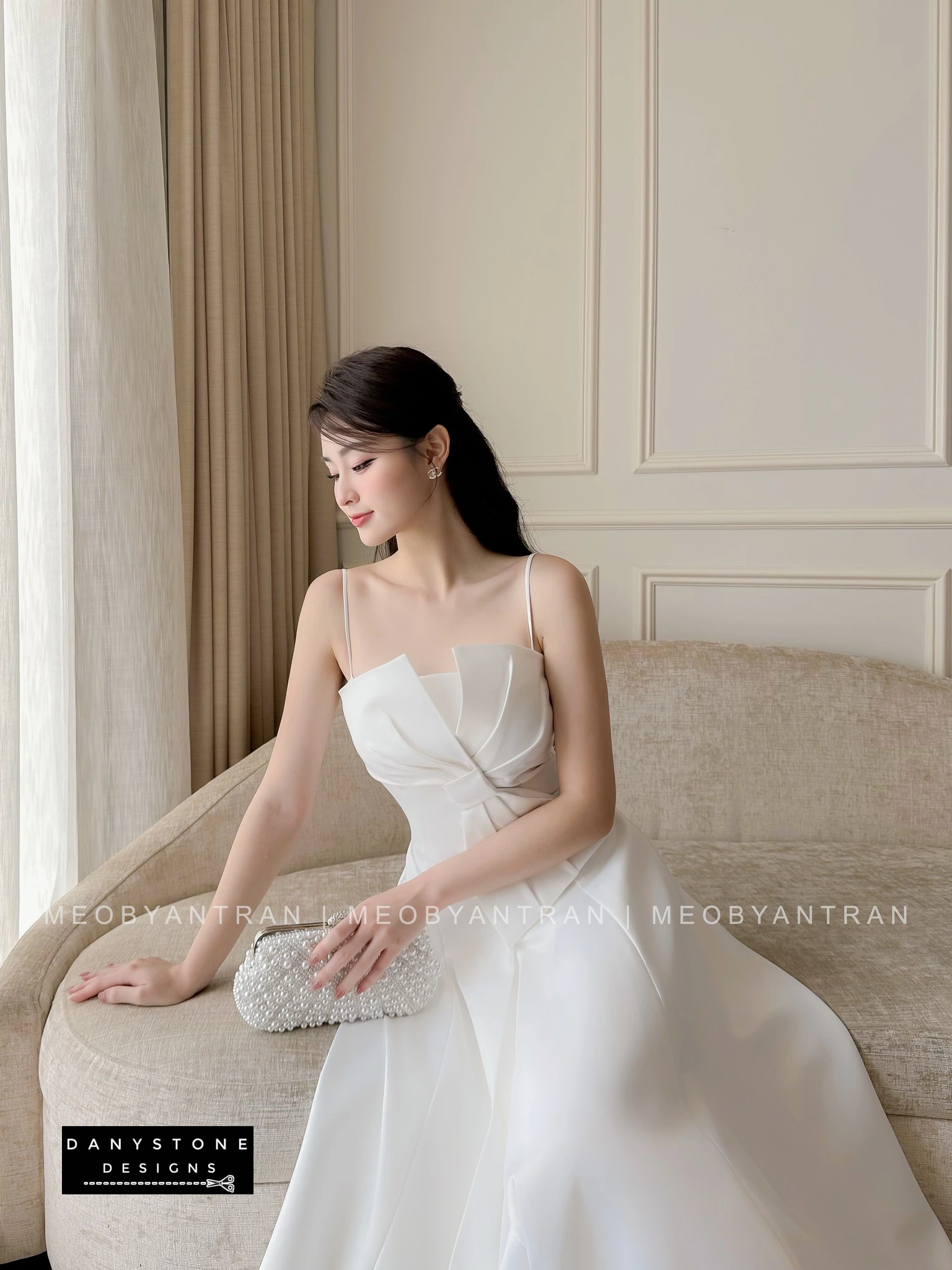 Model Wearing White 2-Strap Bow Accent Dress in Minimalist Setting