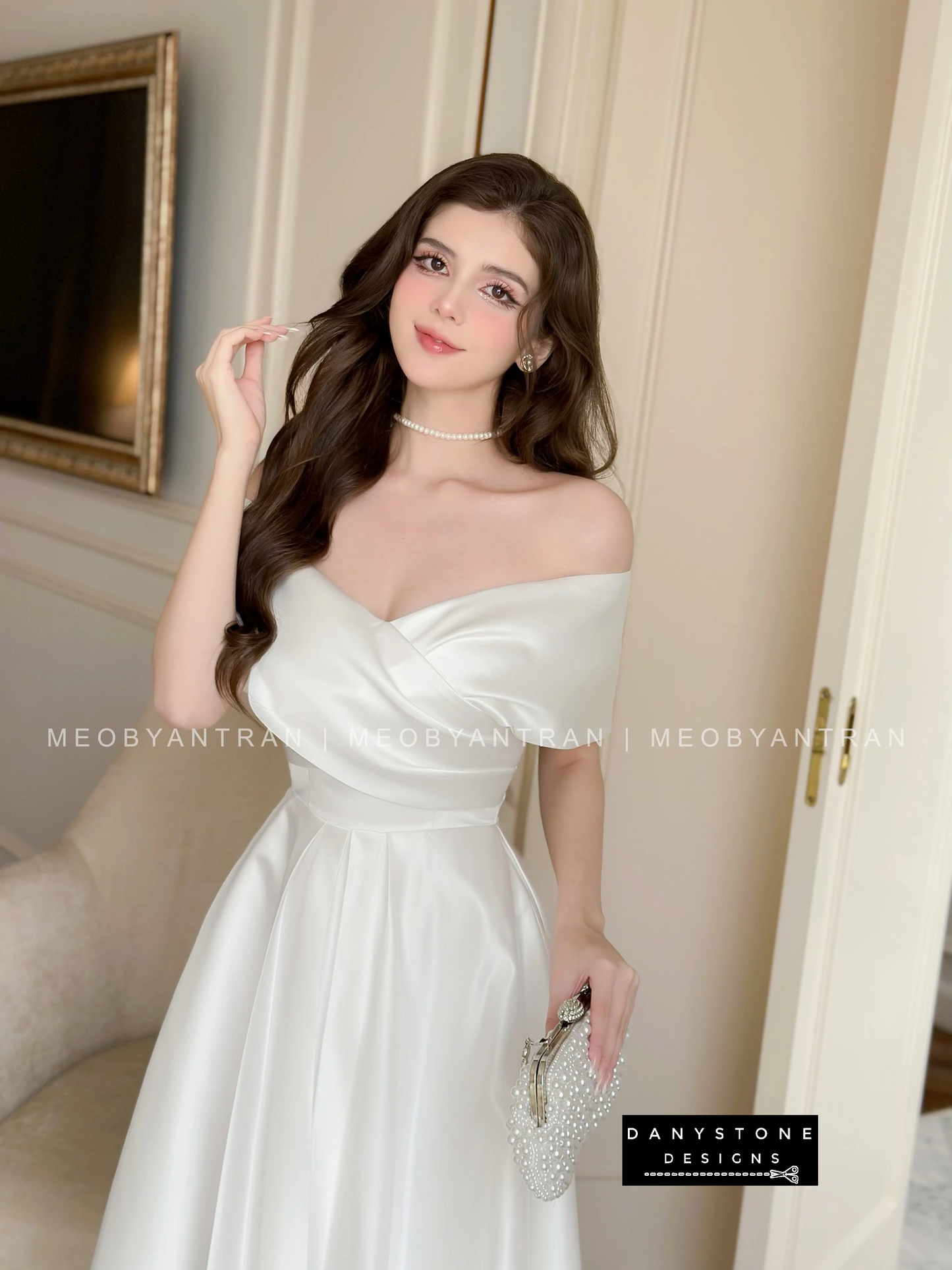 Model Wearing White Off-Shoulder Party Dress with Clutch