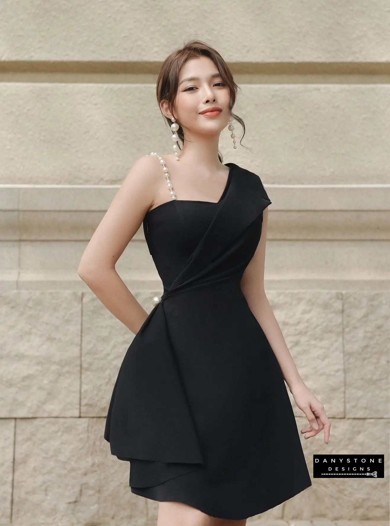 View of Black One-Shoulder Dress Highlighting Flared Skirt