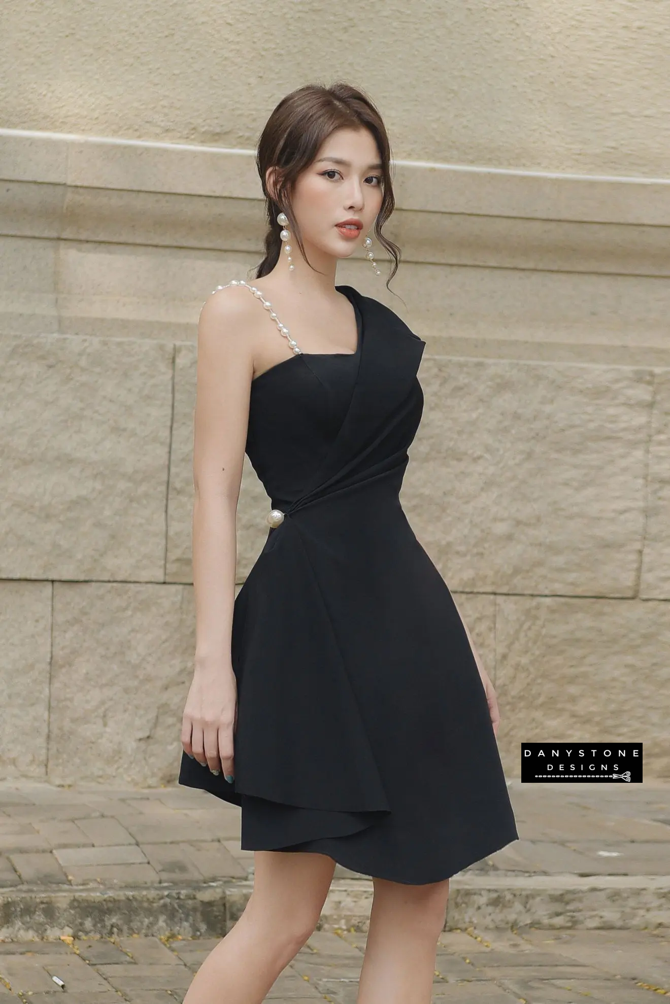 Detailed Shot of Pearl Leaf Strap and Vest Collar on Black Dress