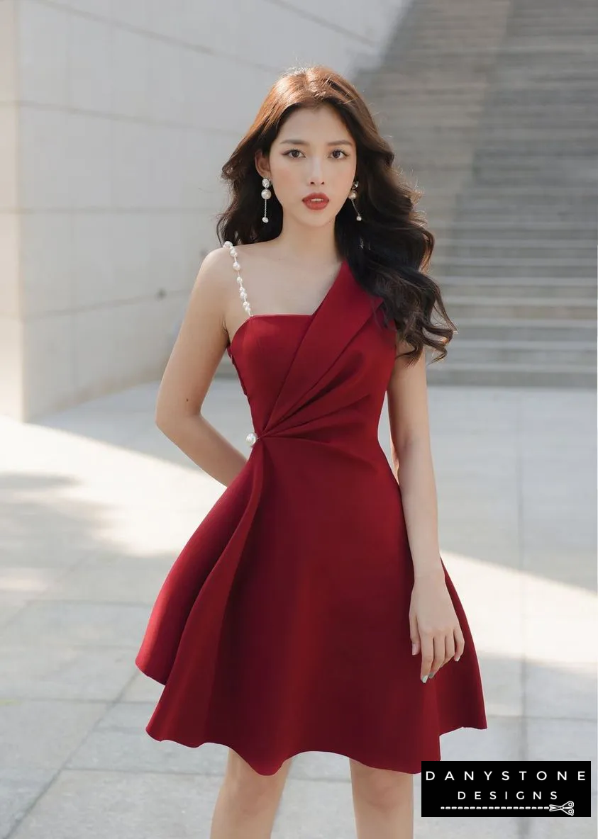 Model Posing in Red One-Shoulder Dress with Elegant Accessories