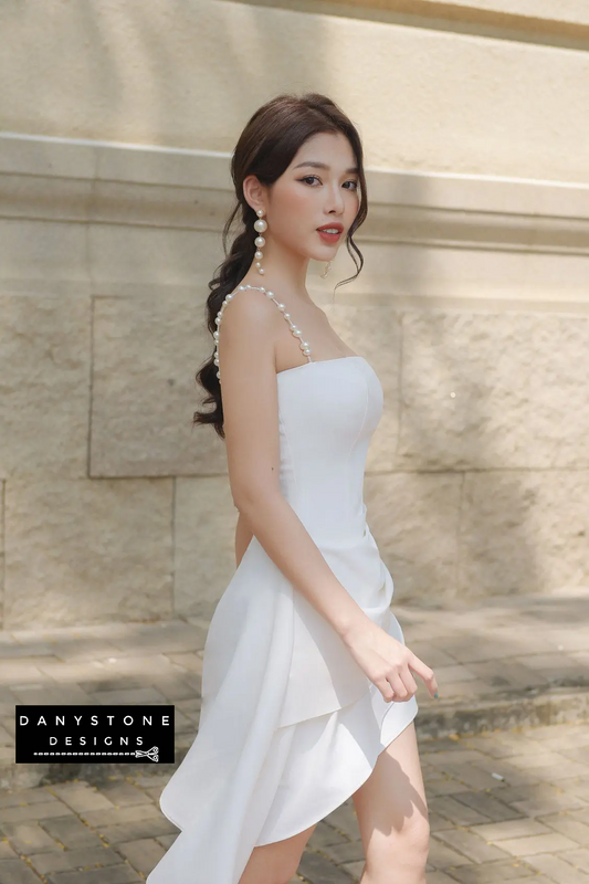 Model Wearing White Pearl Strap Flared Dress with Diagonal Skirt