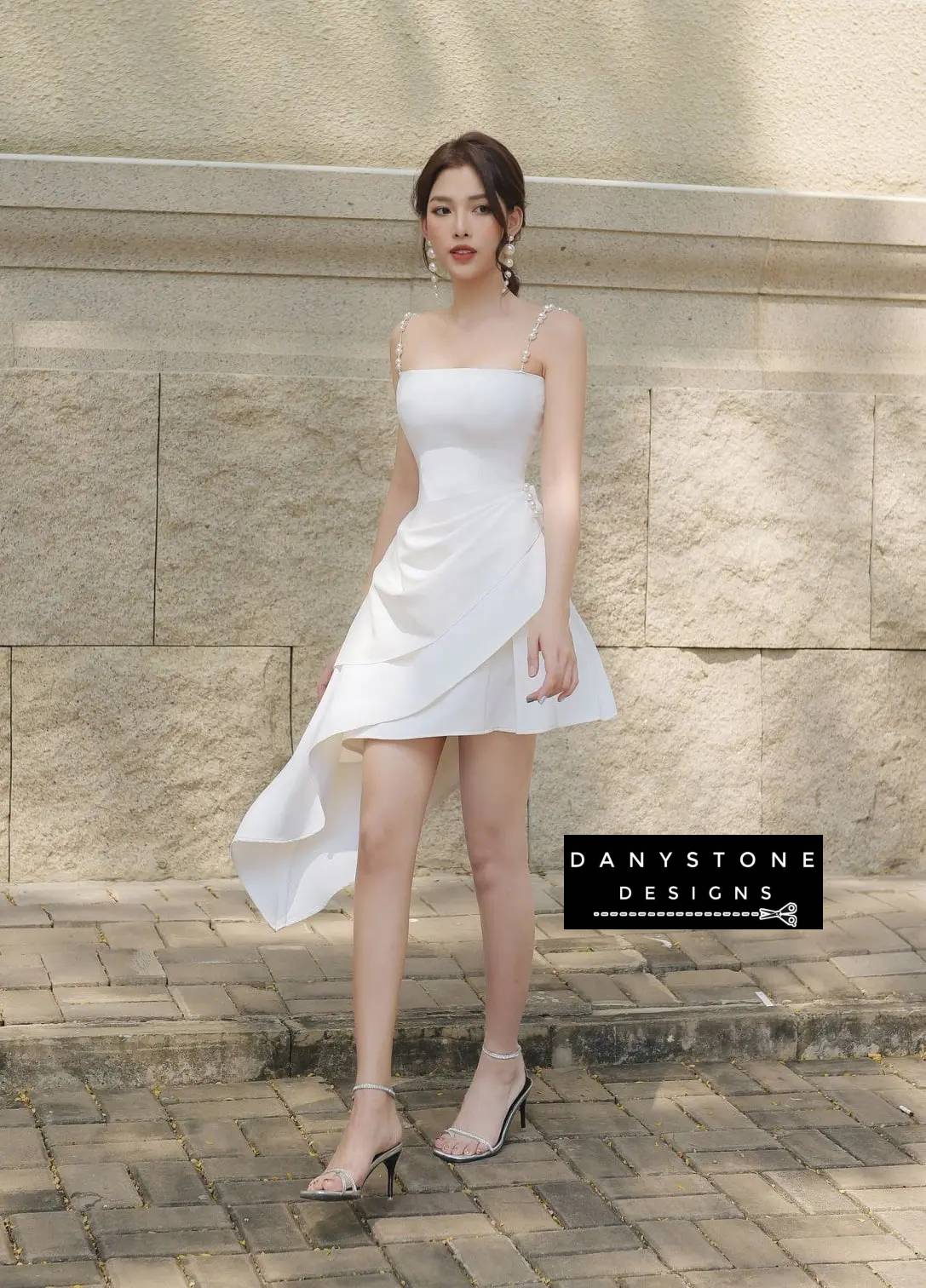 Model in White Pearl Strap Dress with Elegant Pearl Earrings