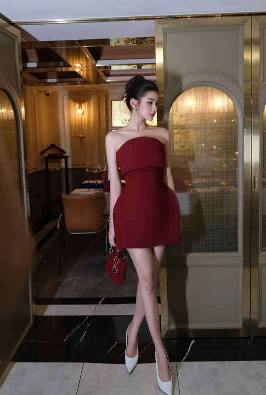 Woman in a red dress standing in an elegant interior setting