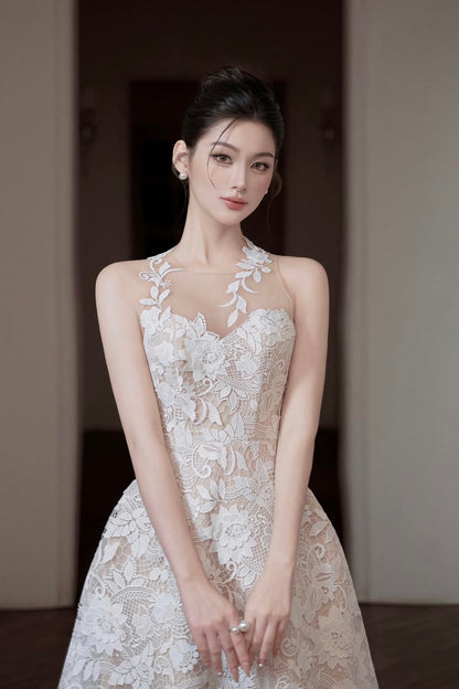 Woman wearing a white lace dress in an indoor setting
