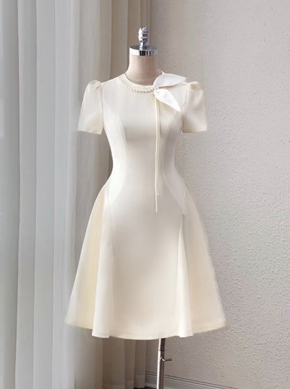 White dress on a mannequin against a plain background