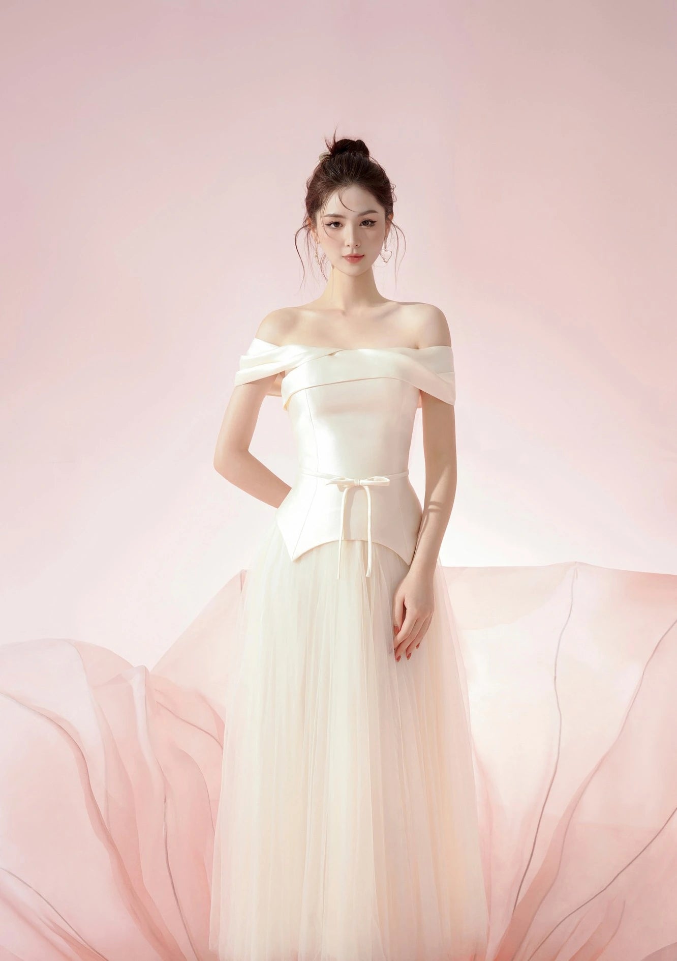 Woman in a white off-shoulder gown against a pink background