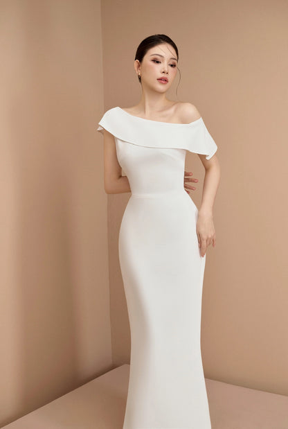 Woman wearing a white off-shoulder gown against a beige background