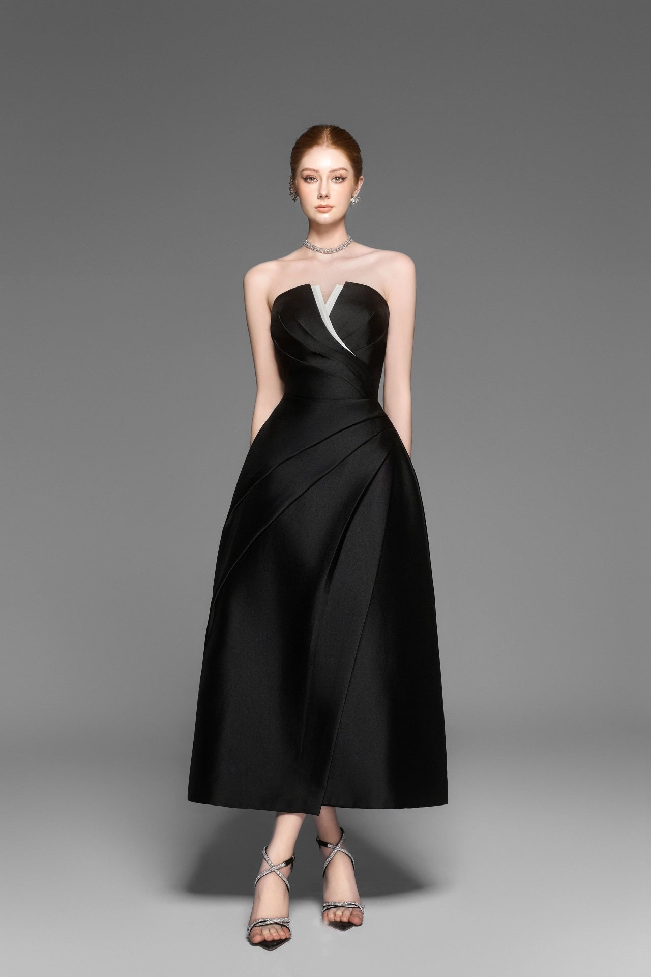 Elegant black strapless pleated dress side profile