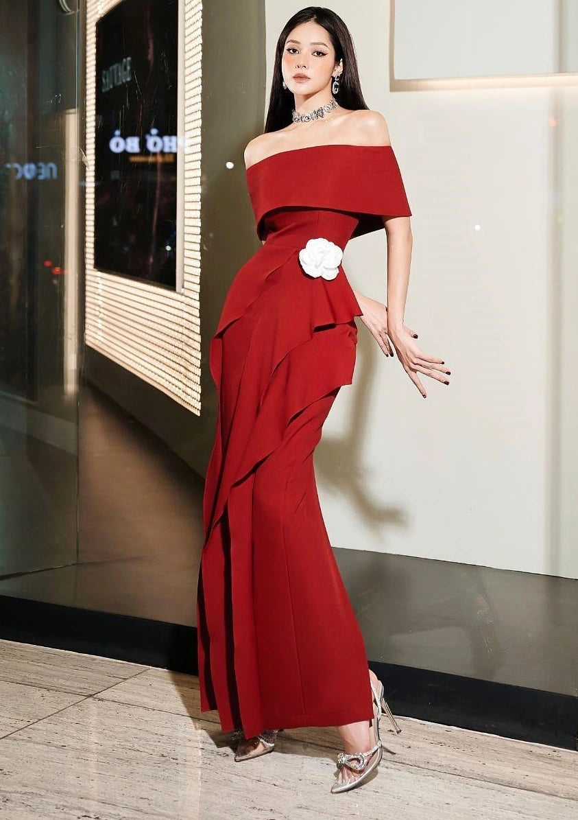 Model posing in youthful burgundy off-shoulder dress