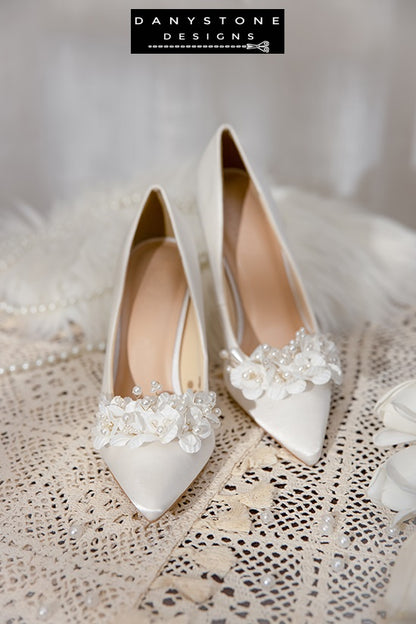 Detailed view of the floral and pearl embellishments on Elegant White Silk Satin Wedding Heels.