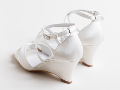 White wedding shoes with a strap on a light background