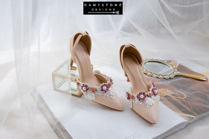 Close-up of nude bridal shoes with floral lace trim and pearls, made from matte pink cream leather, 9cm heel.