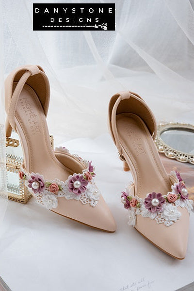 Close-up of nude bridal shoes with floral lace trim and pearls, made from matte pink cream leather, 9cm heel.